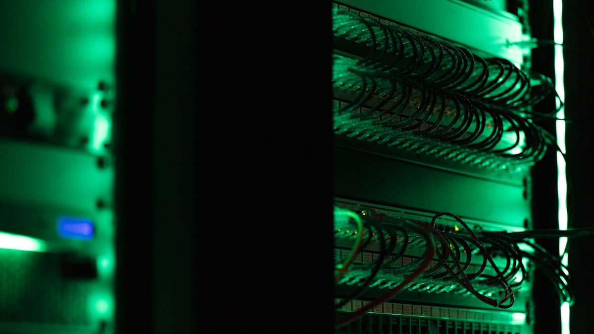 Rows of illuminated server racks in a dark data center, representing the hyperscale infrastructure behind 2026 cloud capex boom